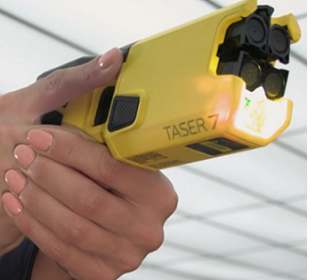 Woman hands holding Taser 7
